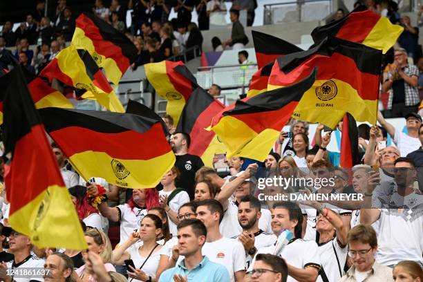 Germany fans wave flags prior to the UEFA Women's Euro 2022 Group B football match between Germany and Spain at Brentford Community Stadium in west...