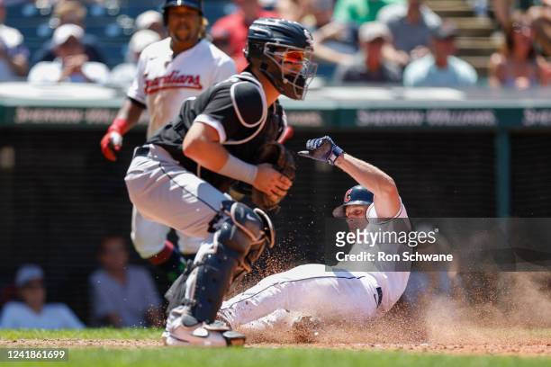 Myles Straw of the Cleveland Guardians scores past Reese McGuire of the Chicago White Sox during the fifth inning of game one of a doubleheader at...
