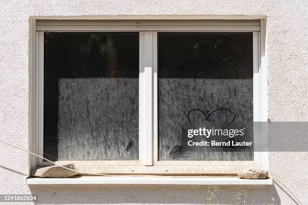 Heart is painted in the dust on a window on July 12, 2022 in Schuld, DEU, Deutschland, Germany. On the evening of July 14 heavy flooding of the Ahr...