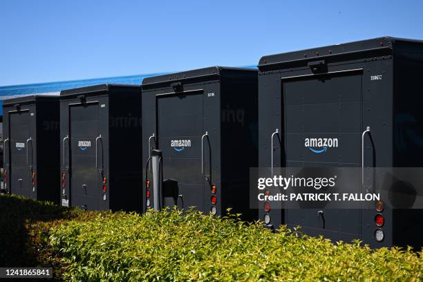 The Amazon logo is displayed on delivery vehicles parked outside of an Amazon.com Inc. Delivery hub on Amazon Prime Day, July 12, 2022 in Torrance,...