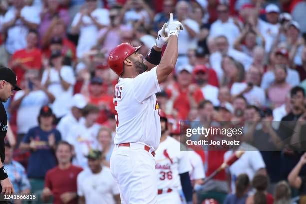 Albert Pujols of the St. Louis Cardinals reacts after hitting a solo home run against the Los Angeles Dodgers in the second inning at Busch Stadium...