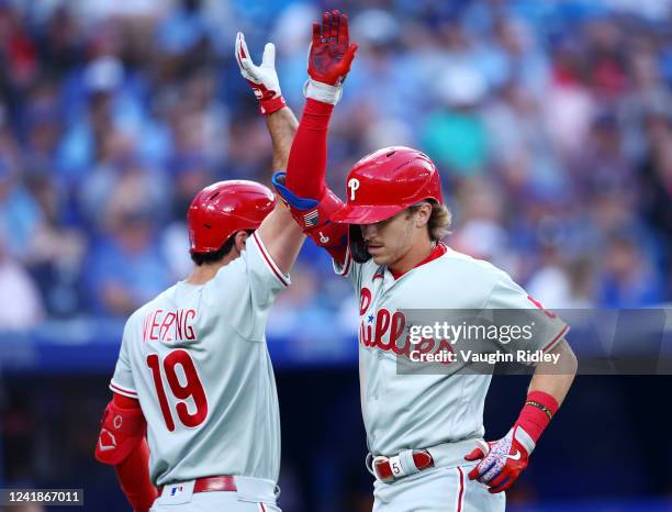 Bryson Stott of the Philadelphia Phillies celebrates with Matt Vierling after hitting a solo home run in the fourth inning against the Toronto Blue...