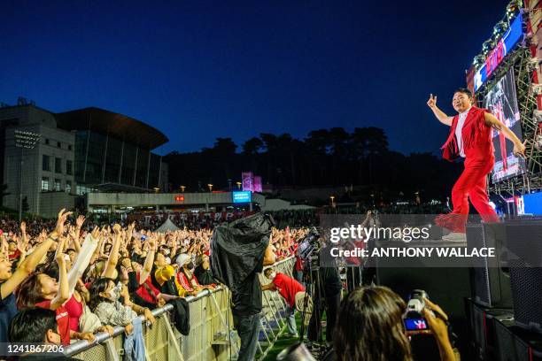 In this picture taken on May 27 fans react as South Korean rapper Psy performs during a concert at the Korea University in Seoul. Newcomers to the...