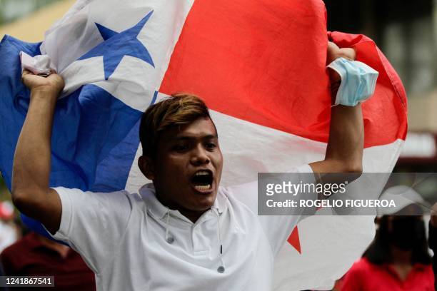 Protester waves Panamanian flag during a march against the high cost of food and gasoline in Panama City, on July 12, 2022. - Despite the...