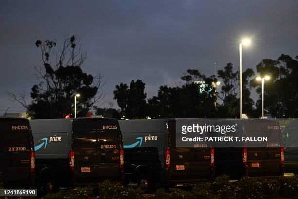 The Amazon Prime logo is displayed on parked Dodge Ram ProMaster delivery vans outside of an Amazon.com Inc. Delivery hub in the late evening of...
