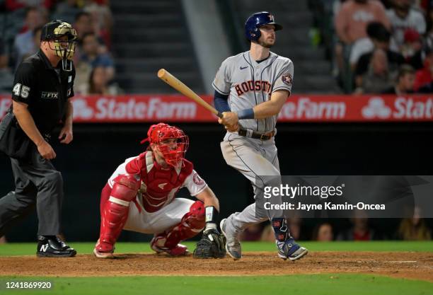Kyle Tucker of the Houston Astros doubles to score Jose Altuve for the go-ahead run in the ninth inning against the Los Angeles Angels at Angel...