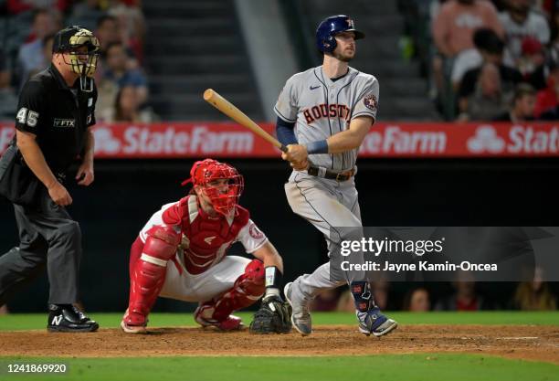 Kyle Tucker of the Houston Astros doubles to score Jose Altuve for the go-ahead run in the ninth inning against the Los Angeles Angels at Angel...