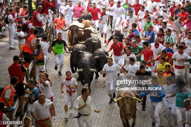 Participants run ahead of bulls during the "encierro" of the San Fermin festival in Pamplona, northern Spain on July 13, 2022. On each day of the...