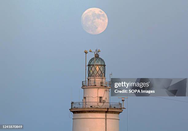 The full moon is rising over the Malaga lighthouse. The second supermoon, known as the 'Deer supermoon', is visible from 12 to 13 July. The supermoon...