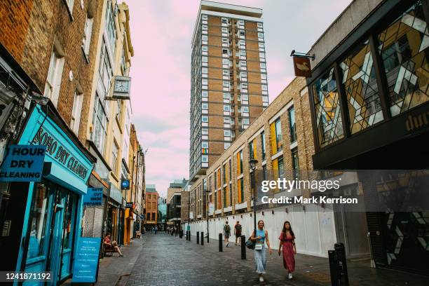 People pass along Berwick Street in Soho on 11th July 2022 in London, United Kingdom. Berwick Street has seen major redevelopment in the past decade,...