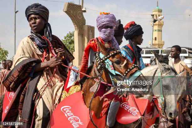Young people wearing traditional clothes ride horses in Kano, located in northern Nigeria and the capital of Kano State, Nigeria on July 11, 2022.