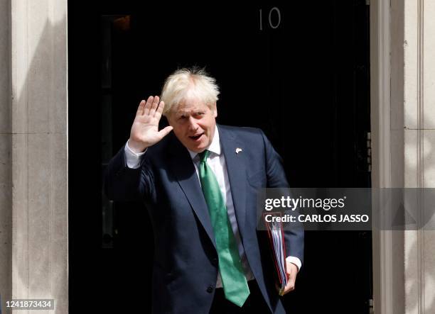 Britain's Prime Minister Boris Johnson walks to a waiting car as he leaves from 10 Downing Street in central London on July 13, 2022 to head to the...