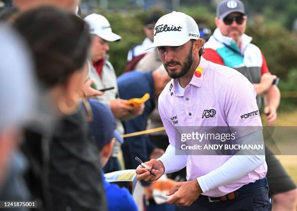 Golfer Max Homa signs autographs during a practice round for The 150th British Open Golf Championship on The Old Course at St Andrews in Scotland on...
