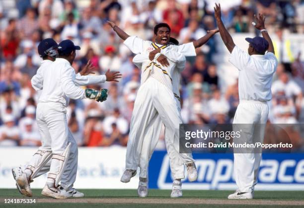 Sri Lanka spin bowler Muttiah Muralitharan is congratulated after taking a wicket during the Cornhill Test match against England at the Kennington...
