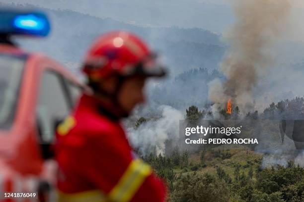 Firefighter looks on during firefighting operations at Espite in Ourem on July 13, 2022. France and Britain suffered soaring temperatures, edging...