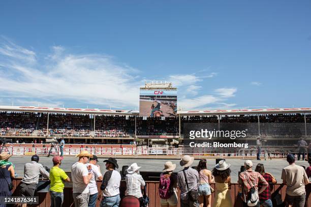 Spectators at the rodeo at the Calgary Stampede in Calgary, Alberta, Canada, on Tuesday, July 12, 2022. The biggest party in Canada's oil patch is...
