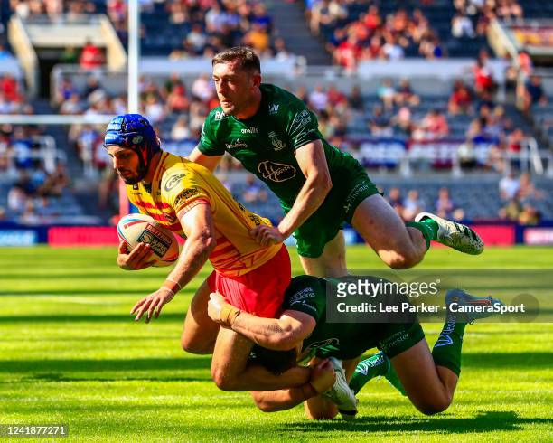 Benjamin Jullien of Catalan Dragons is tackled by George Williams and Matty Ashton of Warrington Wolves during the Betfred Super League Magic Weekend...