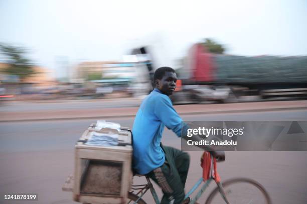 Man rides a bike as daily life continues in Ouagadougou, Burkina Faso on July 12, 2022. Burkina Faso, where approximately 20 million people live,...