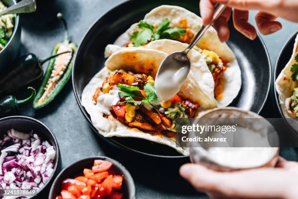 chef preparing vegan tacos - sprinkling stock pictures, royalty-free photos & images