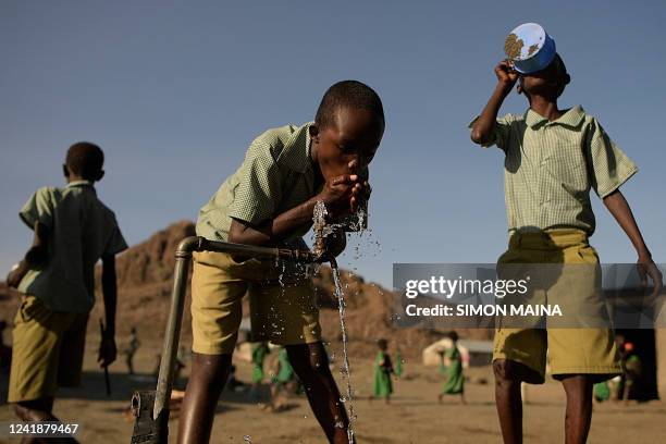 Pupils of El-molo bay primary school drink from a tap, in Loiyangalani, northern Kenya, on July 13, 2022. - At least 18 million people across the...