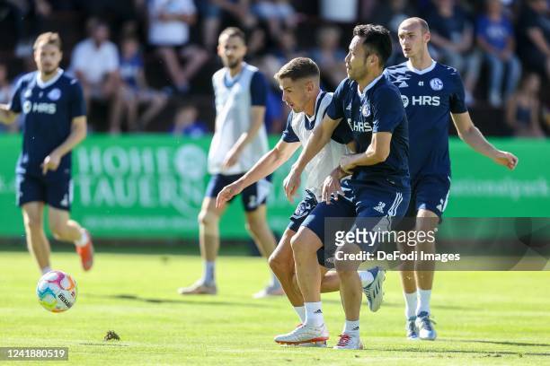 Marvin Pieringer of FC Schalke 04 and Maya Yoshida of FC Schalke 04 battle for the ball during the FC Schalke 04 Pre-Season Training Session on July...
