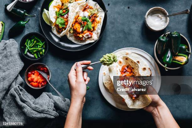 woman preparing tasty vegan tacos - vegetarian meal stock pictures, royalty-free photos & images