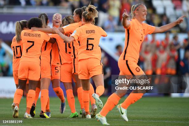 Netherlands' players celebrate the opening goal scored by Netherlands' midfielder Damaris Egurrola during the UEFA Women's Euro 2022 Group C football...