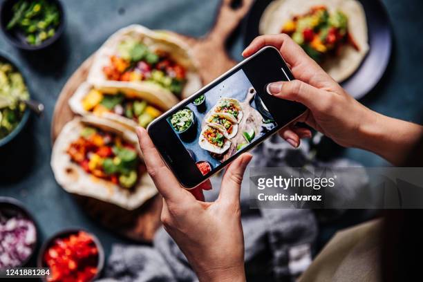 hands of cook photographing mexican tacos - photography themes stock pictures, royalty-free photos & images