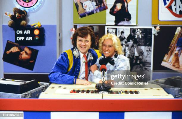 Harry Enfield and Paul Whitehouse as Smashey and Nicey, show off the Nose and the Comic Relief Comic Book of Red Nose Day 1991 in 1991 in England.