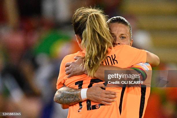 Netherlands' midfielder Danielle van de Donk and Netherlands' midfielder Sherida Spitse celebrate their victory at the end of the UEFA Women's Euro...