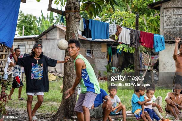 Locals play volleyball in the afternoon in a village near the beach. Daily life in Moalboal District, Cebu, Philippines. The area once known for its...
