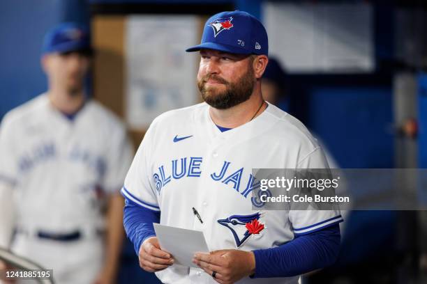 Interim manager John Schneider of the Toronto Blue Jays holds the lineup card in the dugout ahead of the game against the Philadelphia Phillies at...