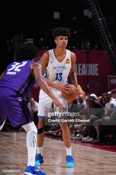 Ousmane Dieng of the Oklahoma City Thunder dribbles the ball during the game against the Sacramento Kings during the 2022 Las Vegas Summer League on...