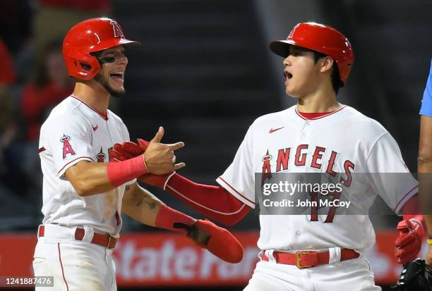 Andrew Velazquez of the Los Angeles Angels and Shohei Ohtani celebrate after they were driven in by Luis Rengifo in the sixth inning while playing...