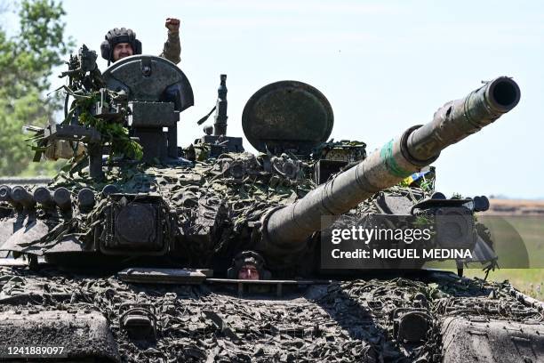 Ukrainian servicemen drive a T-72 tank on the frontline in eastern Ukraine on July 13 amid the Russian invasion of Ukraine.