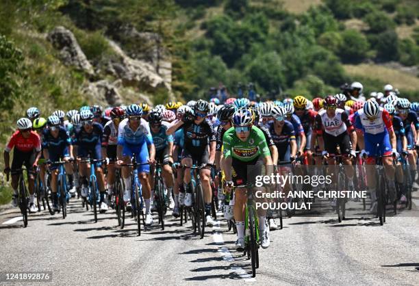 Jumbo-Visma team's Belgian rider Wout Van Aert wearing the sprinter's green jersey cycles ahead of the pack during the 12th stage of the 109th...