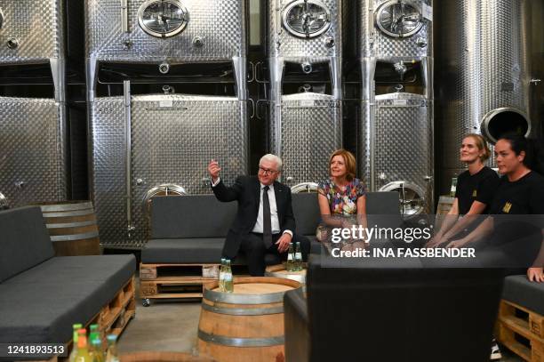 German President Frank-Walter Steinmeier and Rhineland-Palatinate's State Premier Malu Dreyer sit with the winegrowers in the cellar during their...