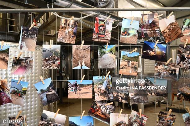 Photos taken during the floods have been attached on a grid in a hall of the vineyard Meyer-Nakel on the sidelines of a visit by the German President...