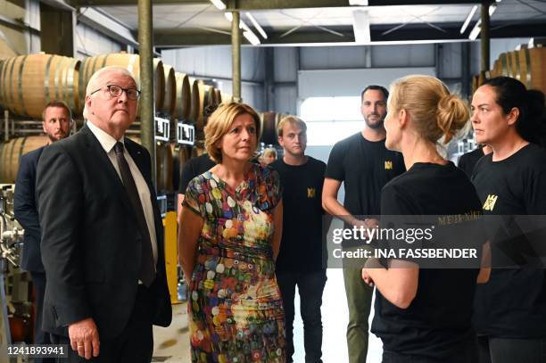 German President Frank-Walter Steinmeier and Rhineland-Palatinate's State Premier Malu Dreyer react as they listen to the winegrower during their...