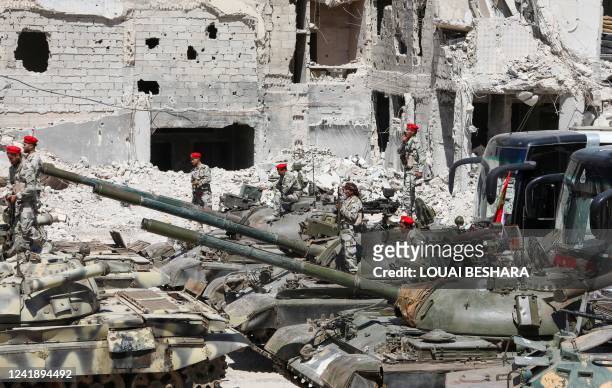 Actors are pictured in the Hajar al-Aswad neighbourhood of the Syrian capital Damascus on July 14 during the filming of a scene in a film titled...
