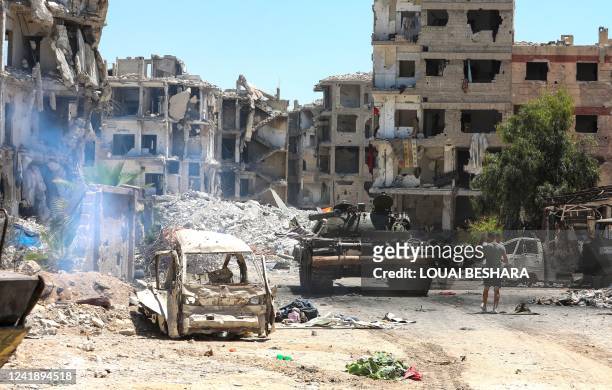 Actors are pictured in the Hajar al-Aswad neighbourhood of the Syrian capital Damascus on July 14 during the filming of a scene in a film titled...