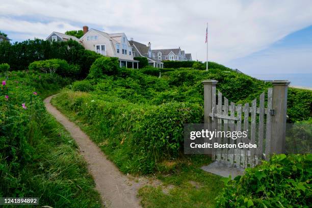 Nantucket, MA The Sconset Bluff Walk in Siasconset, Nantucket, meanders between private seasonal homes and private beach access up towards the...