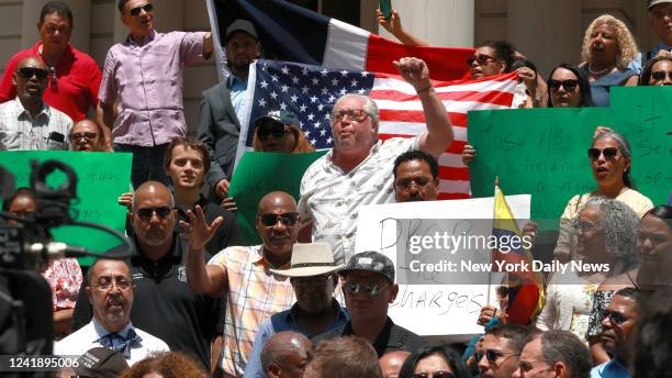 July 13: Members of the Dominican Republic Community, Bodega owners and different associations are pictured on the steps of City Hall during press...