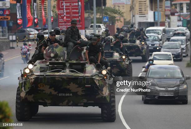 Army soldiers travel in armored vehicles along a road in the Battaramulla area near Colombo On July 14, 2022. The government has declared an...