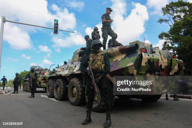 Army personnel in armored vehicles patrol a road in the Battaramulla area near Colombo On July 14, 2022. The government has declared an emergency,...