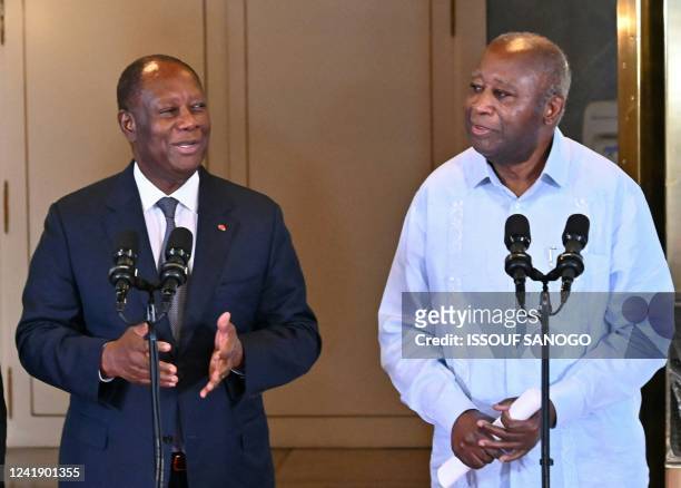 Ivory Coast President Alassane Ouattara speaks next to his predecessors Henri Konan Bedie and Laurent Gbagbo after a meeting at the presidential...