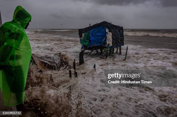 Stalls get damaged and washed away as Arabian Sea waves lash the houses close to the seashore along Versova Beach during high tide amid heavy...