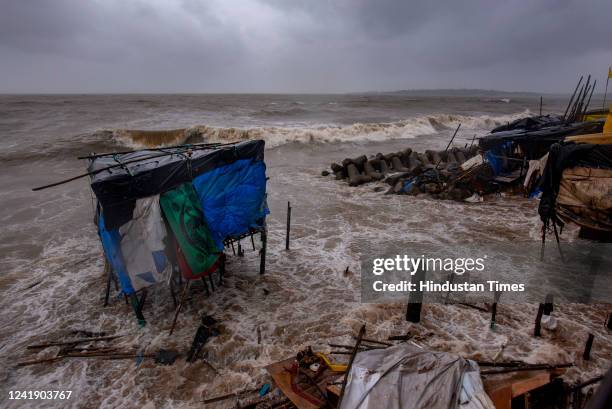 Stalls get damaged and washed away as Arabian Sea waves lash the houses close to the seashore along Versova Beach during high tide amid heavy...