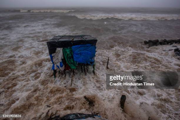 Stalls get damaged and washed away as Arabian Sea waves lash the houses close to the seashore along Versova Beach during high tide amid heavy...