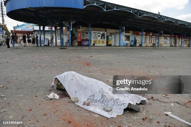 Dead body of a woman is seen on the street after shelling, which killed 2 injured 6, in the Voroshilovsky district of Donetsk, Ukraine on July 14,...